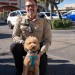 Traveler left her goldendoodle tied up at the airport. A cop came to the rescue
